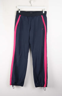 Navy blue pants with pink stripes on a white background