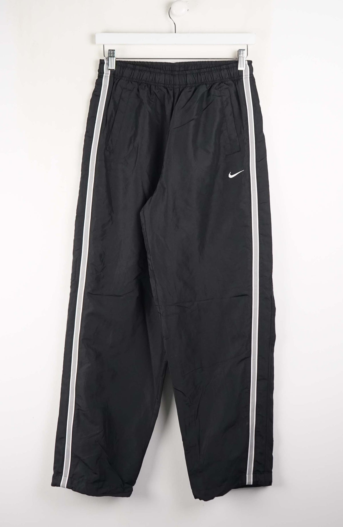 Black pants with white stripes on a white background