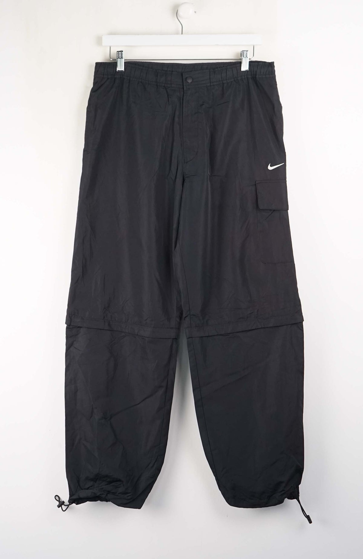 Black cargo pants with a Nike logo on a white background