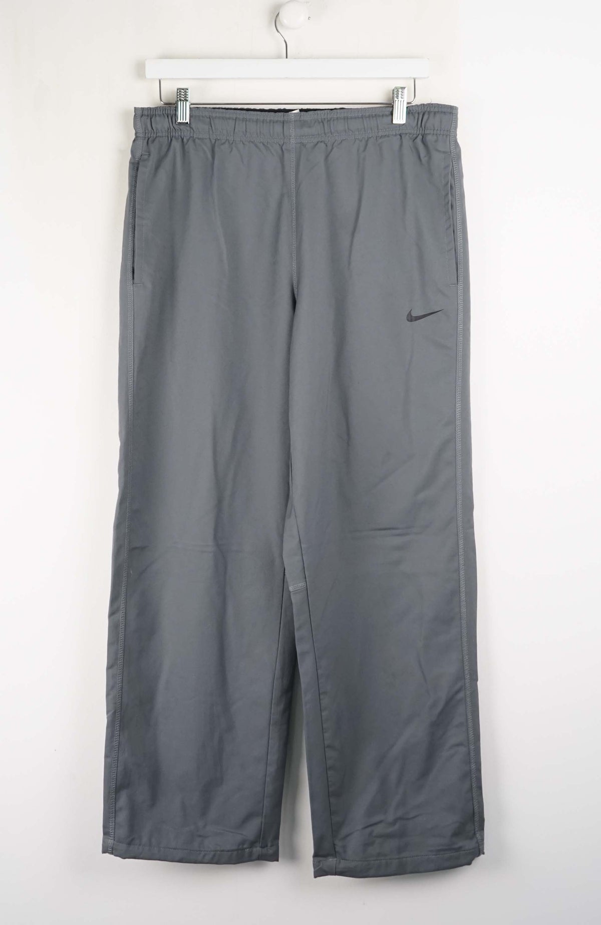 Gray pants with a Nike logo on a white background