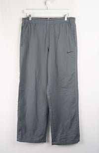Gray pants with a Nike logo on a white background