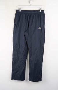 Dark blue pants with a Nike logo on a white background