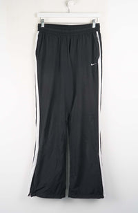 Black athletic pants with a white stripe on a white background