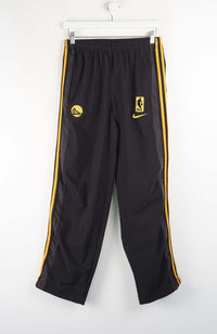 Black athletic pants with yellow stripes and logos on a white background