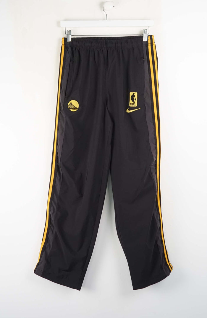 Black athletic pants with yellow stripes and logos on a white background