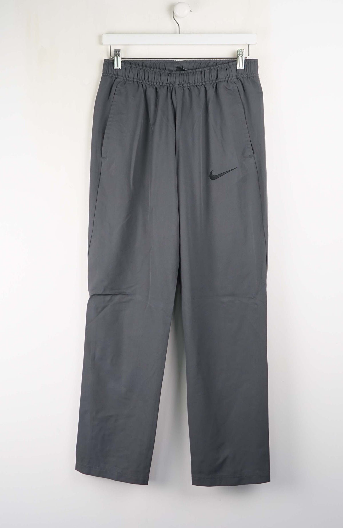 Gray pants with a Nike logo on a white background