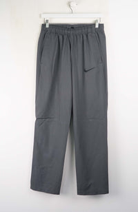 Gray pants with a Nike logo on a white background