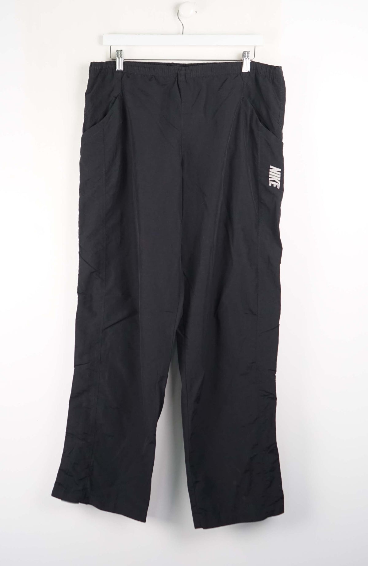 Black pants with a visible brand logo on a white background