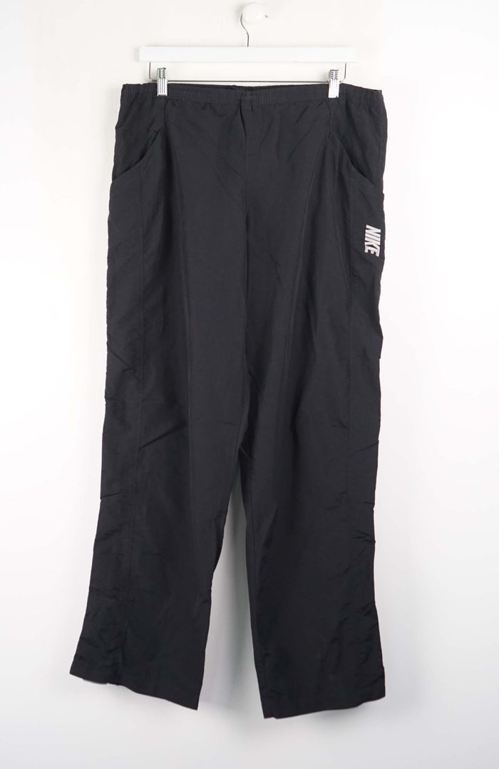 Black pants with a visible brand logo on a white background