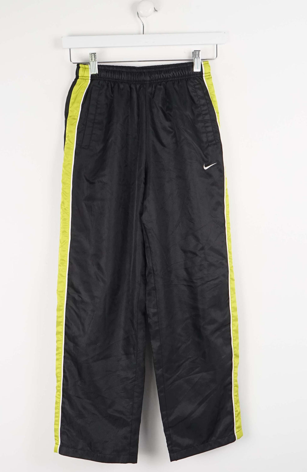 Black athletic pants with yellow stripes on a white background