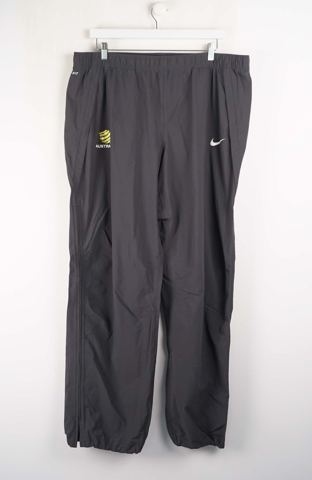 Gray tracksuit pants with logos on a white background