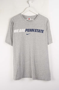 Gray t-shirt with 'We Are Penn State' text and Nike logo on a white background