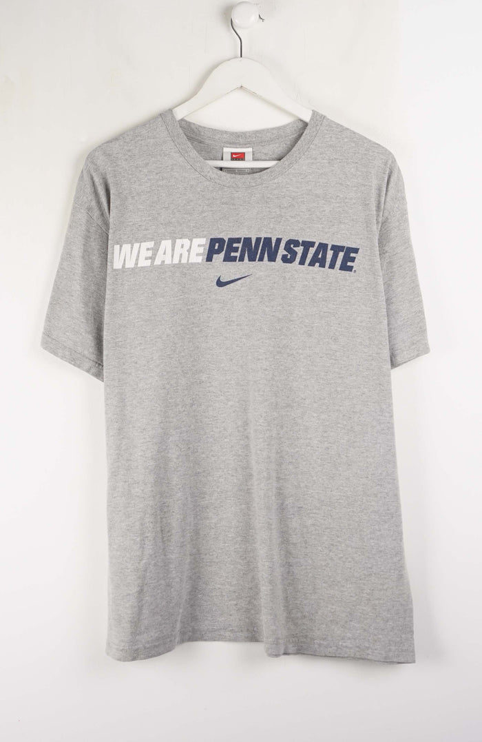 Gray t-shirt with 'We Are Penn State' text and Nike logo on a white background