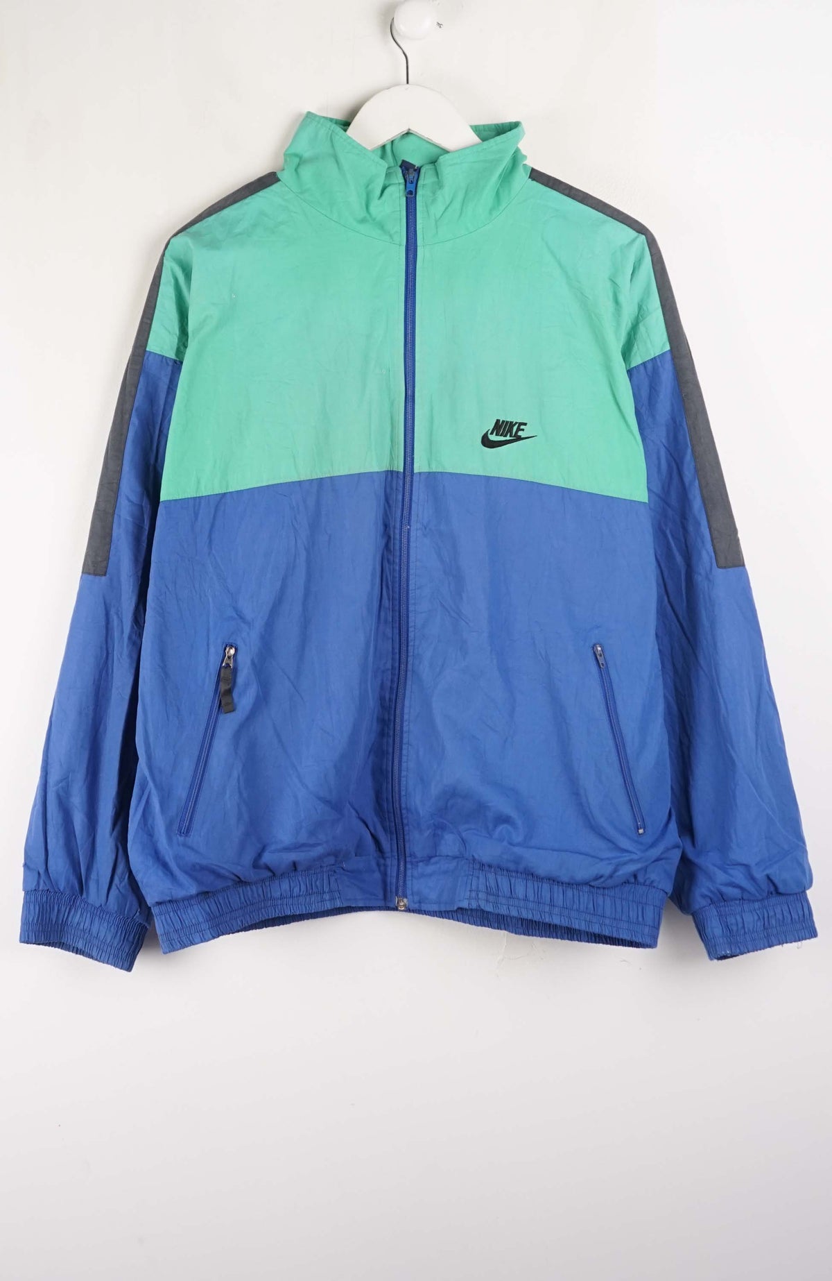 Blue and green jacket with Nike logo on a white background