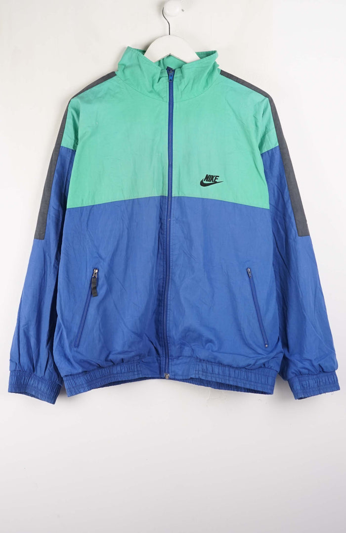 Blue and green jacket with Nike logo on a white background
