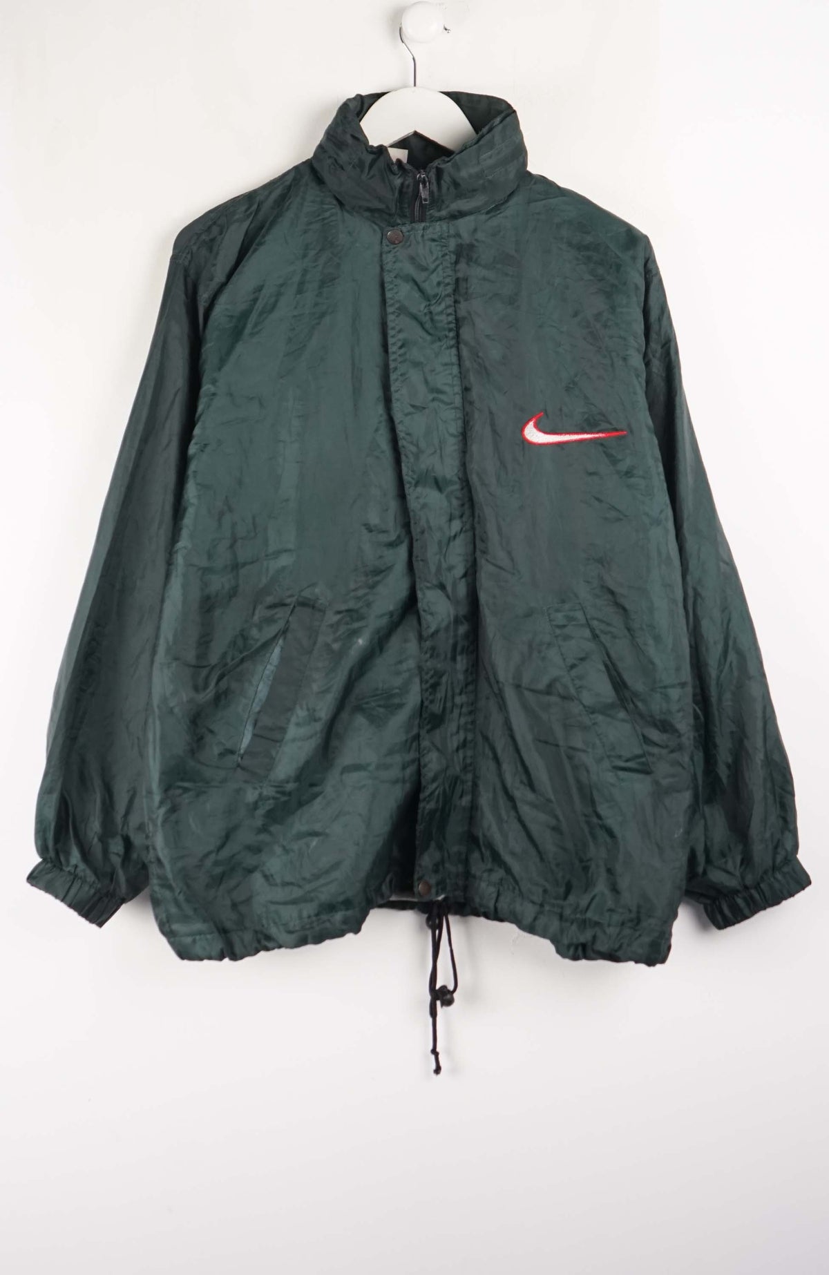 Green jacket with a red Nike logo on a white background