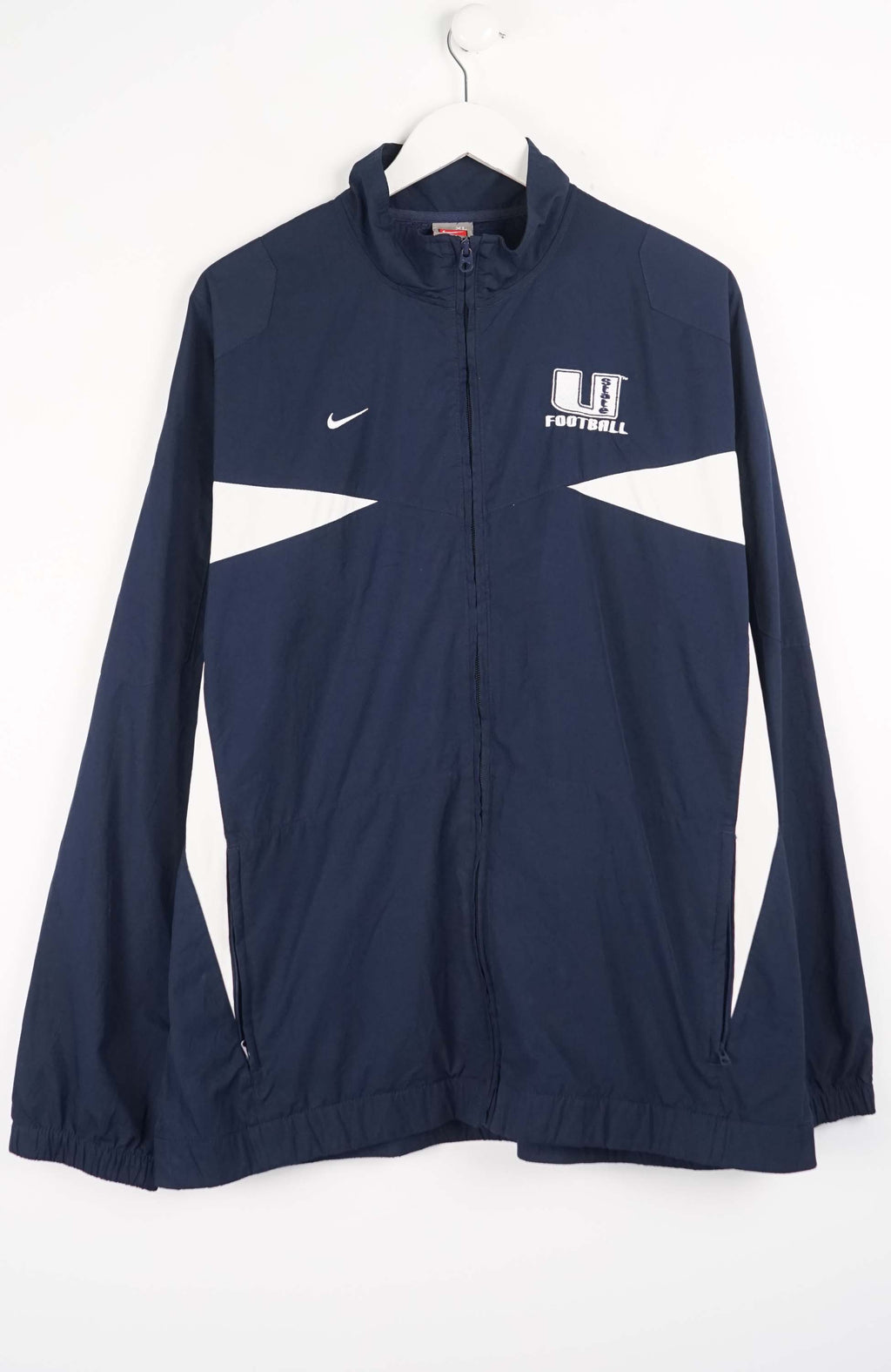 Navy blue sports jacket with white accents on a white background