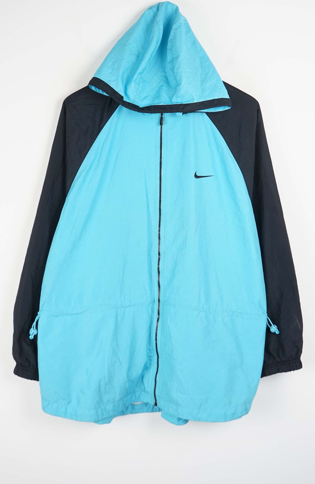 Light blue and black jacket with a hood on a white background