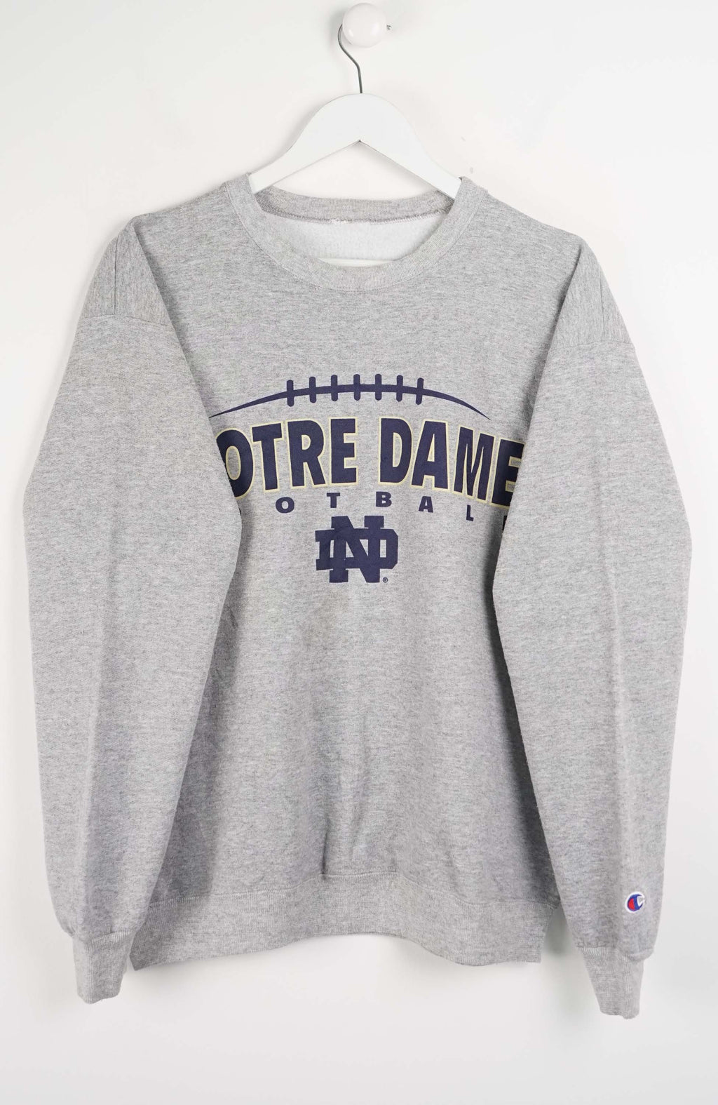 Gray sweatshirt with 'Notre Dame Football' text on a white background