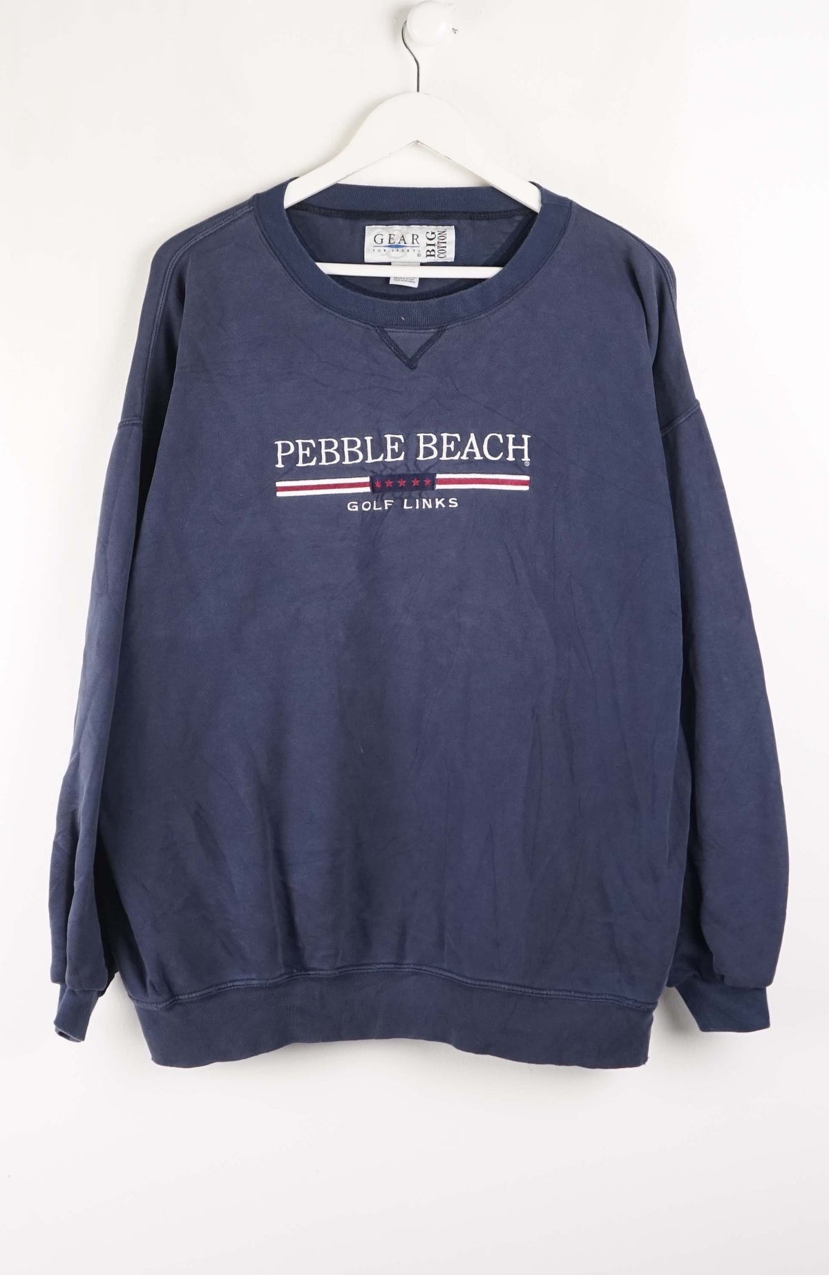 Navy blue sweatshirt with 'Pebble Beach Golf Links' text on a white background