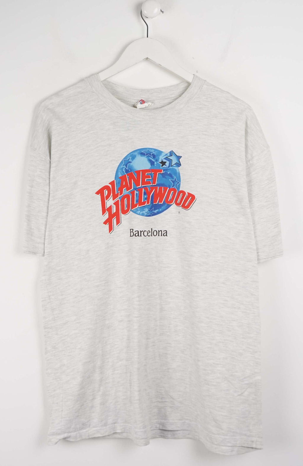 Gray t-shirt with 'Planet Hollywood Barcelona' logo on a white background