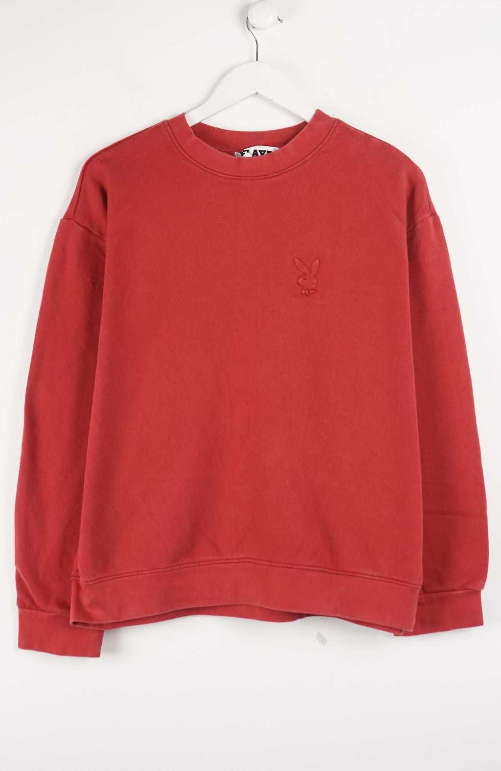Red sweatshirt with a small logo on a white background