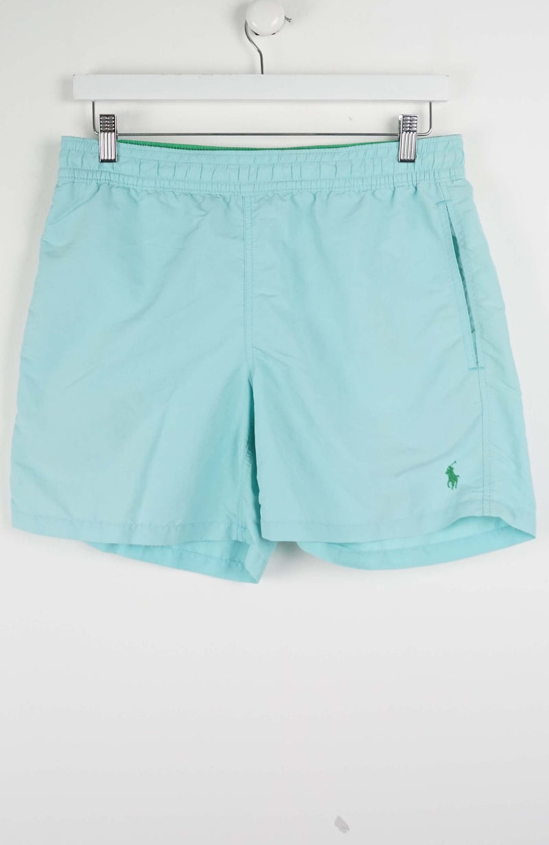 Light blue shorts with a brand logo on a white background