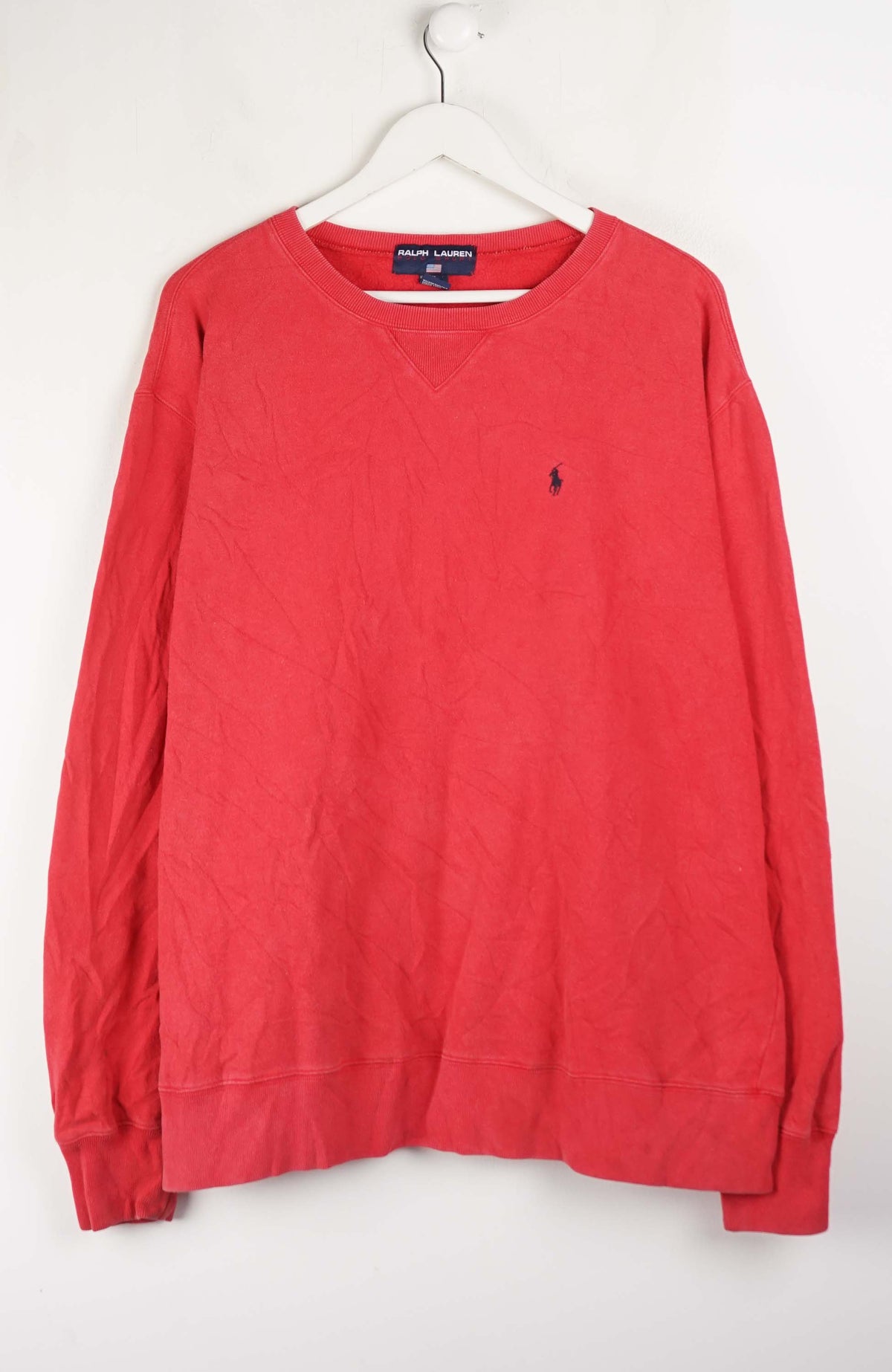 Red sweatshirt with a small logo on a white background