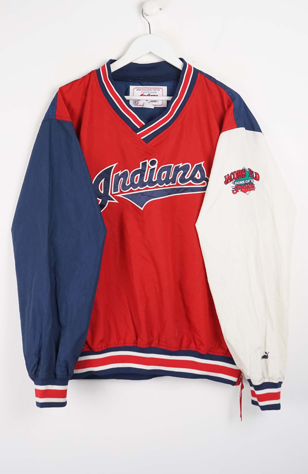 Red and blue sports jersey with 'Indians' branding on a white background