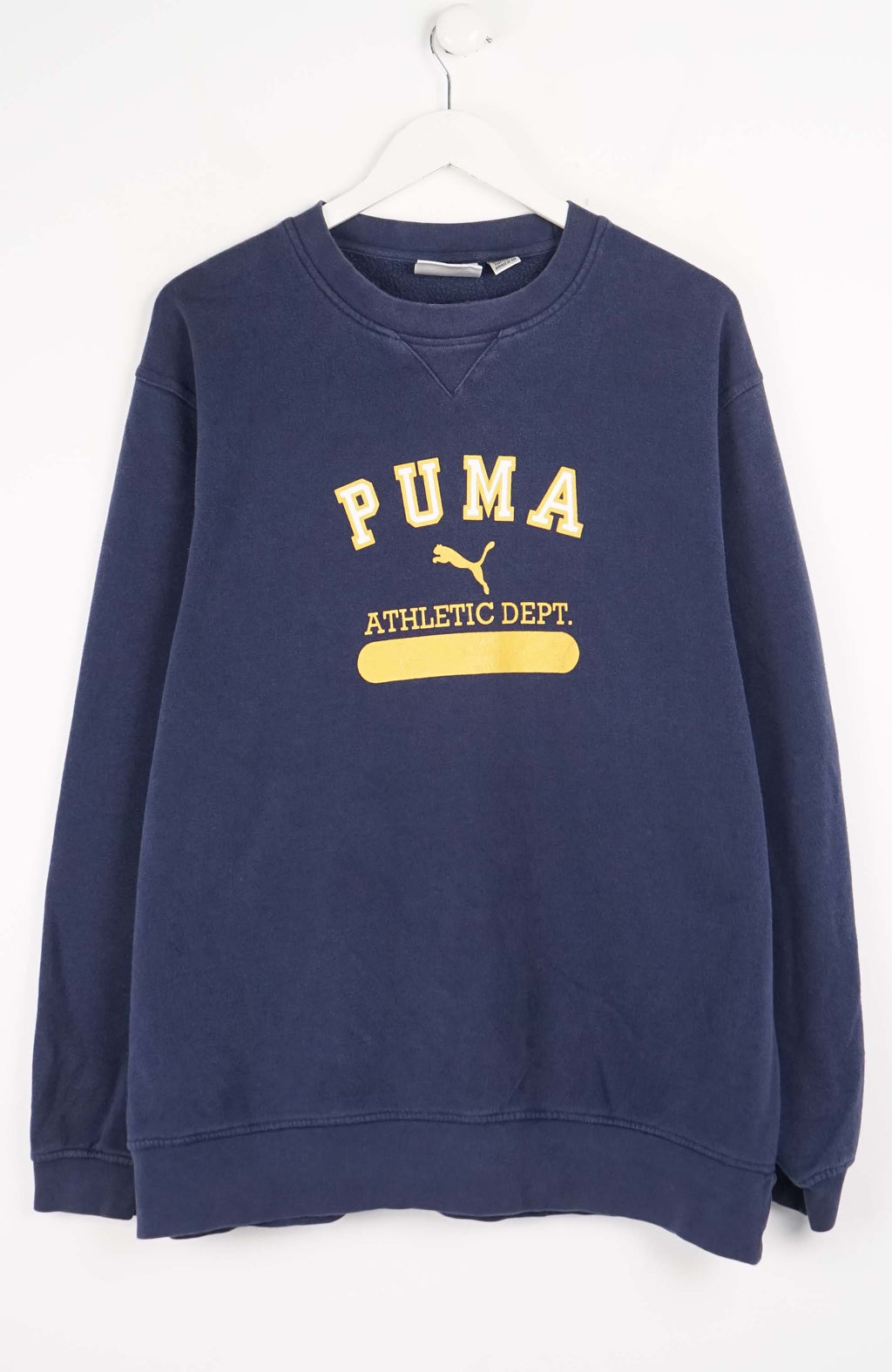 Navy blue Puma sweatshirt with yellow text on a white background