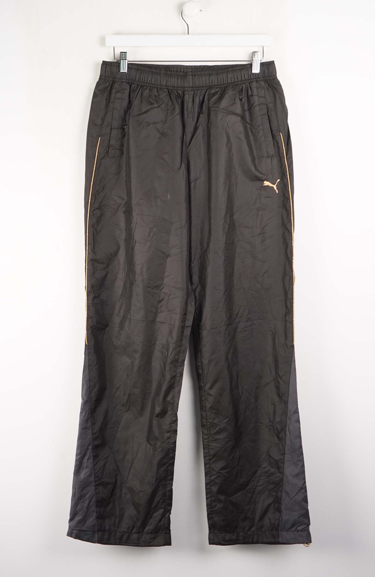 Black athletic pants with a logo on a white background