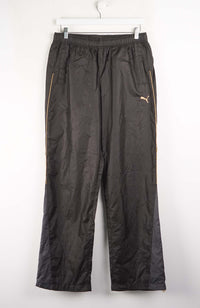 Black athletic pants with a logo on a white background