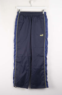 Navy blue pants with a yellow Puma logo on a white background