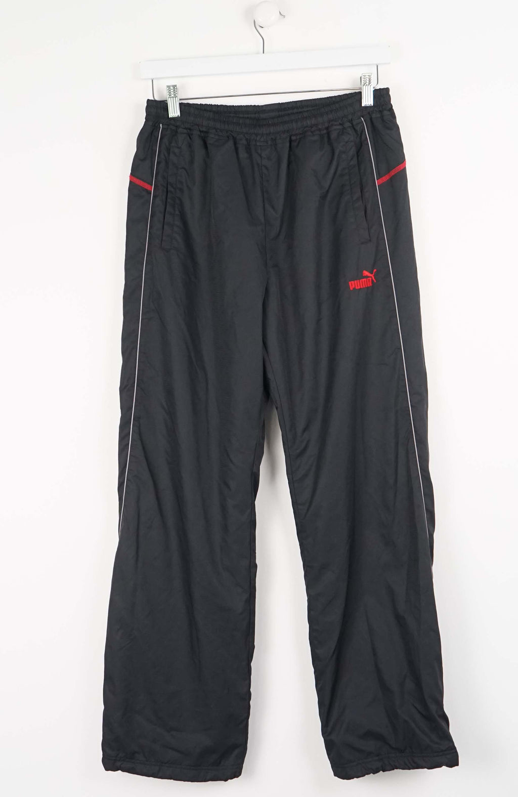 Black pants with red accents on a white background