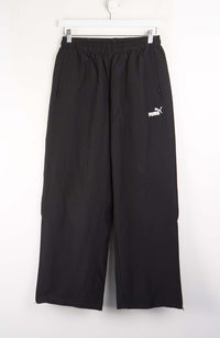 Black pants with a Puma logo on a white background