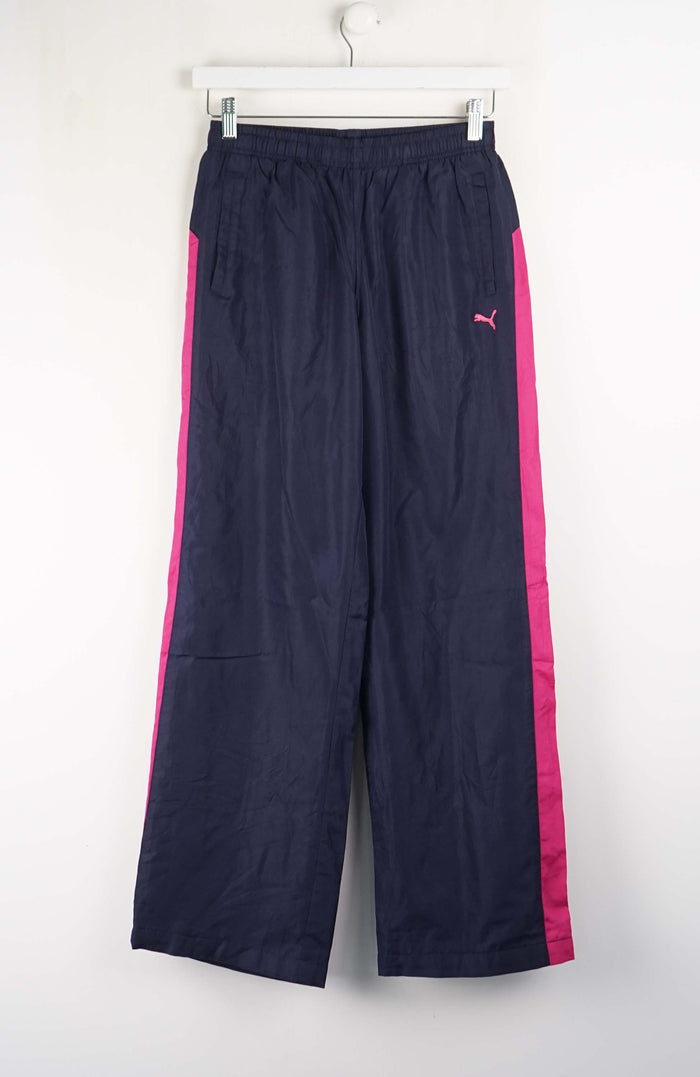 Navy blue pants with pink stripes on a white background