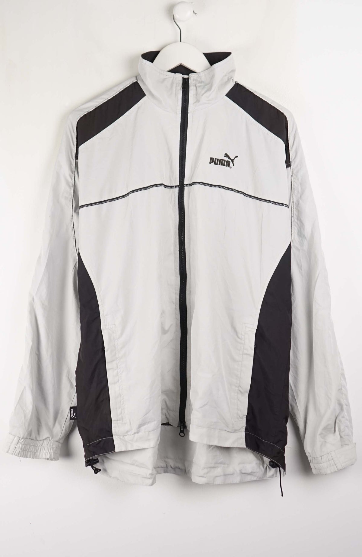 White and black jacket with Puma logo on a white background