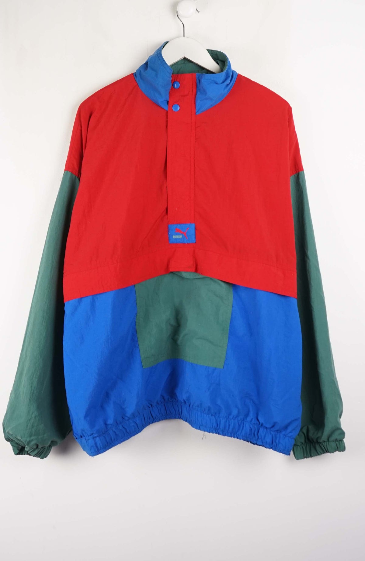 Color-blocked jacket with red, blue, and green sections on a white background