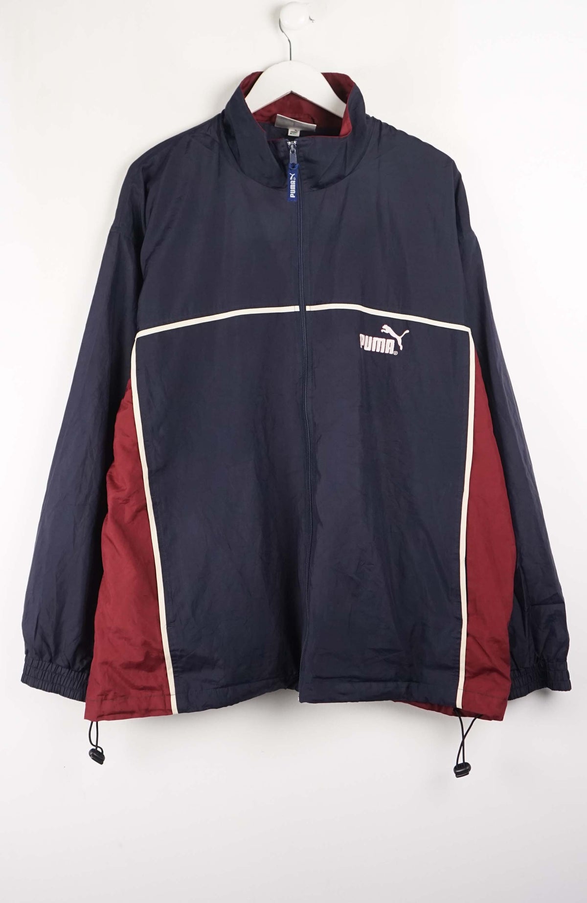 Navy and red jacket with Puma logo on a white background