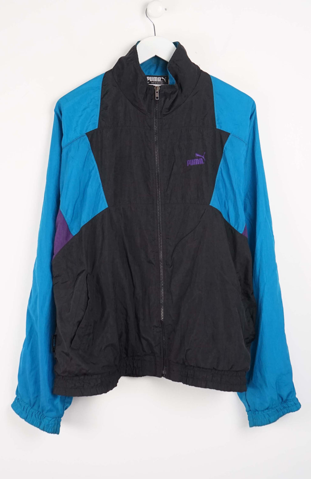 Blue and black jacket with a brand logo on a white background