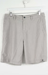 Gray shorts hanging on a white hanger against a white background