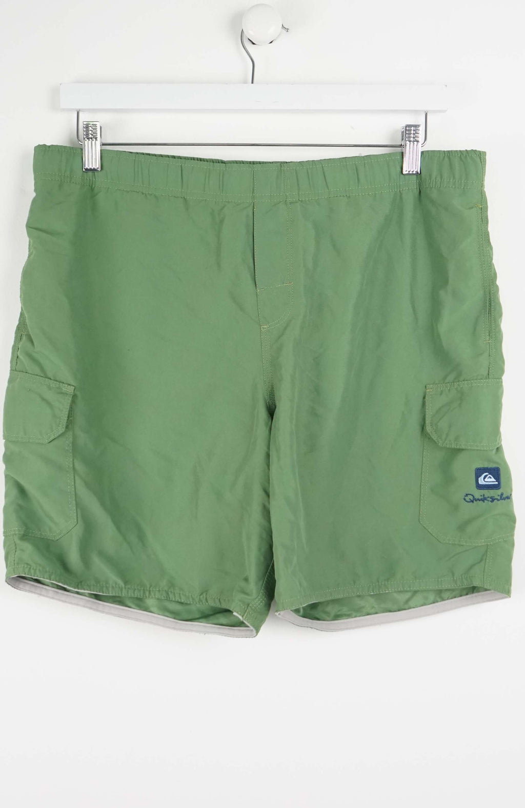 Green shorts with a brand logo on a white background