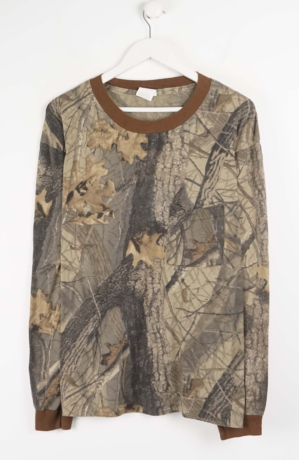 Camouflage-patterned long-sleeve shirt on a white hanger