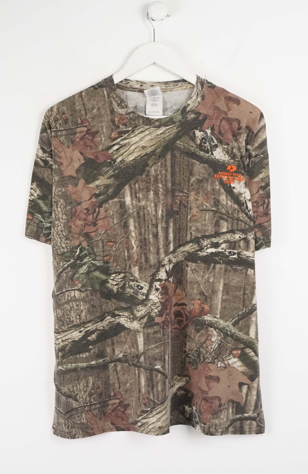 Camouflage-patterned t-shirt on a white hanger
