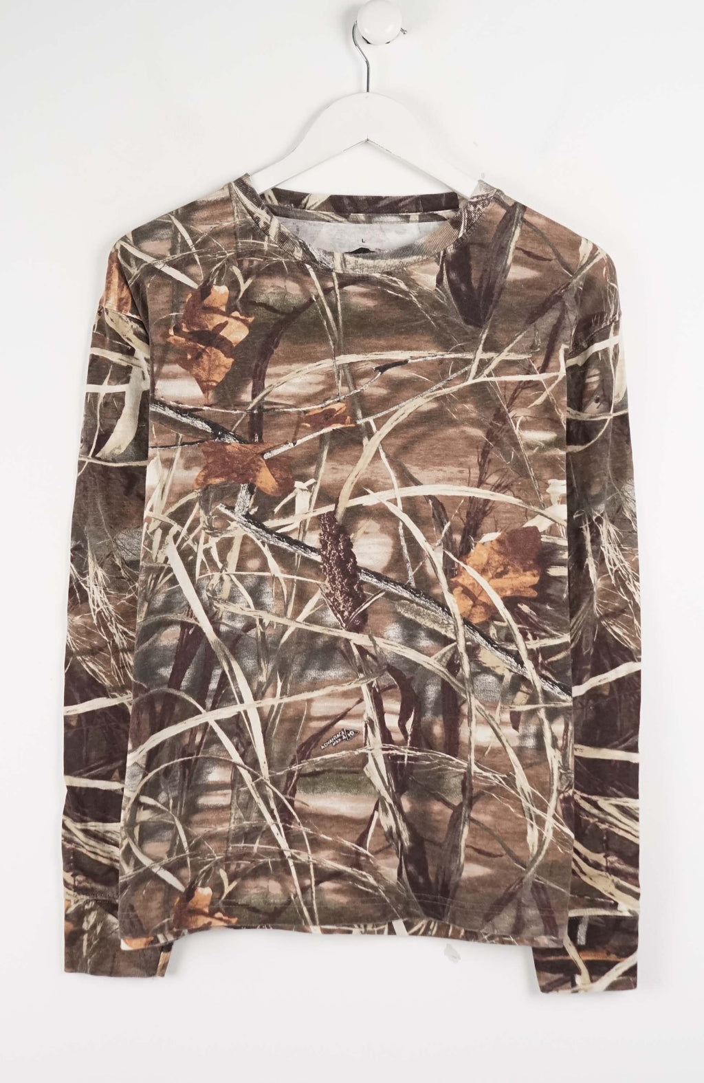 Camouflage-patterned shirt on a white hanger against a white background