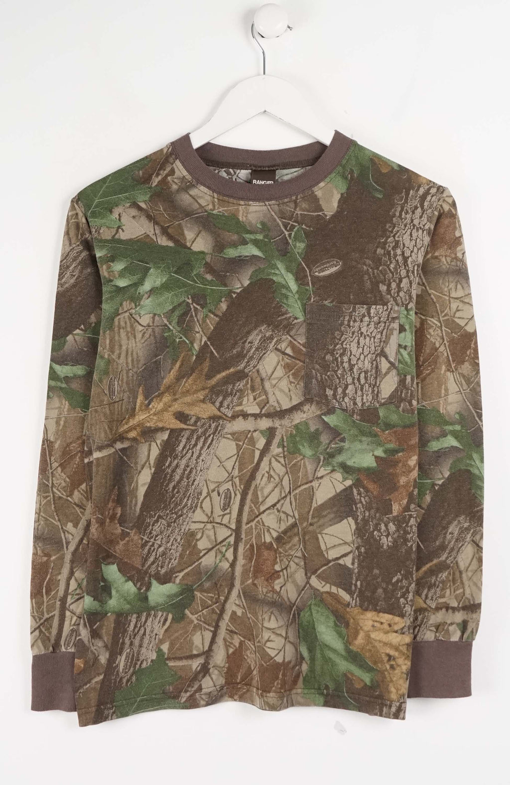 Camouflage-patterned long-sleeve shirt on a white hanger against a white background