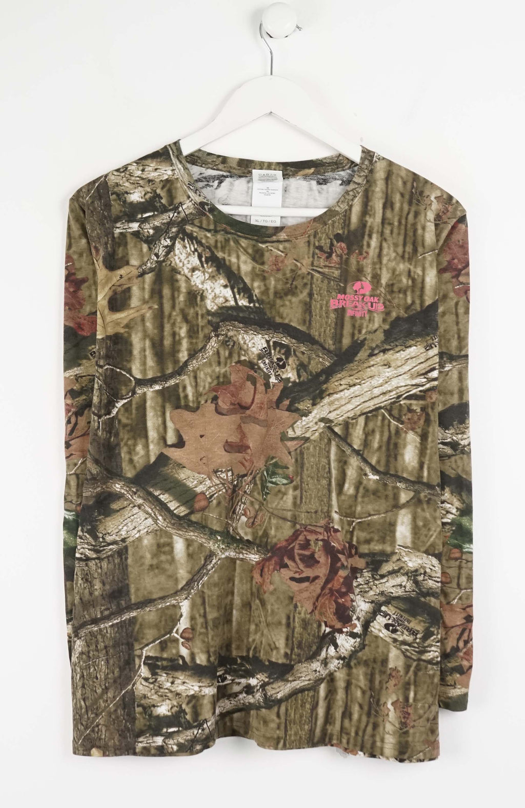 Camouflage-patterned shirt on a hanger against a white background