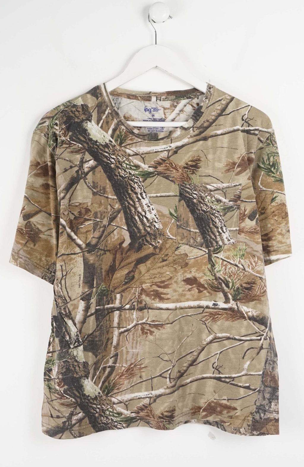 Camouflage-patterned shirt on a hanger against a white background