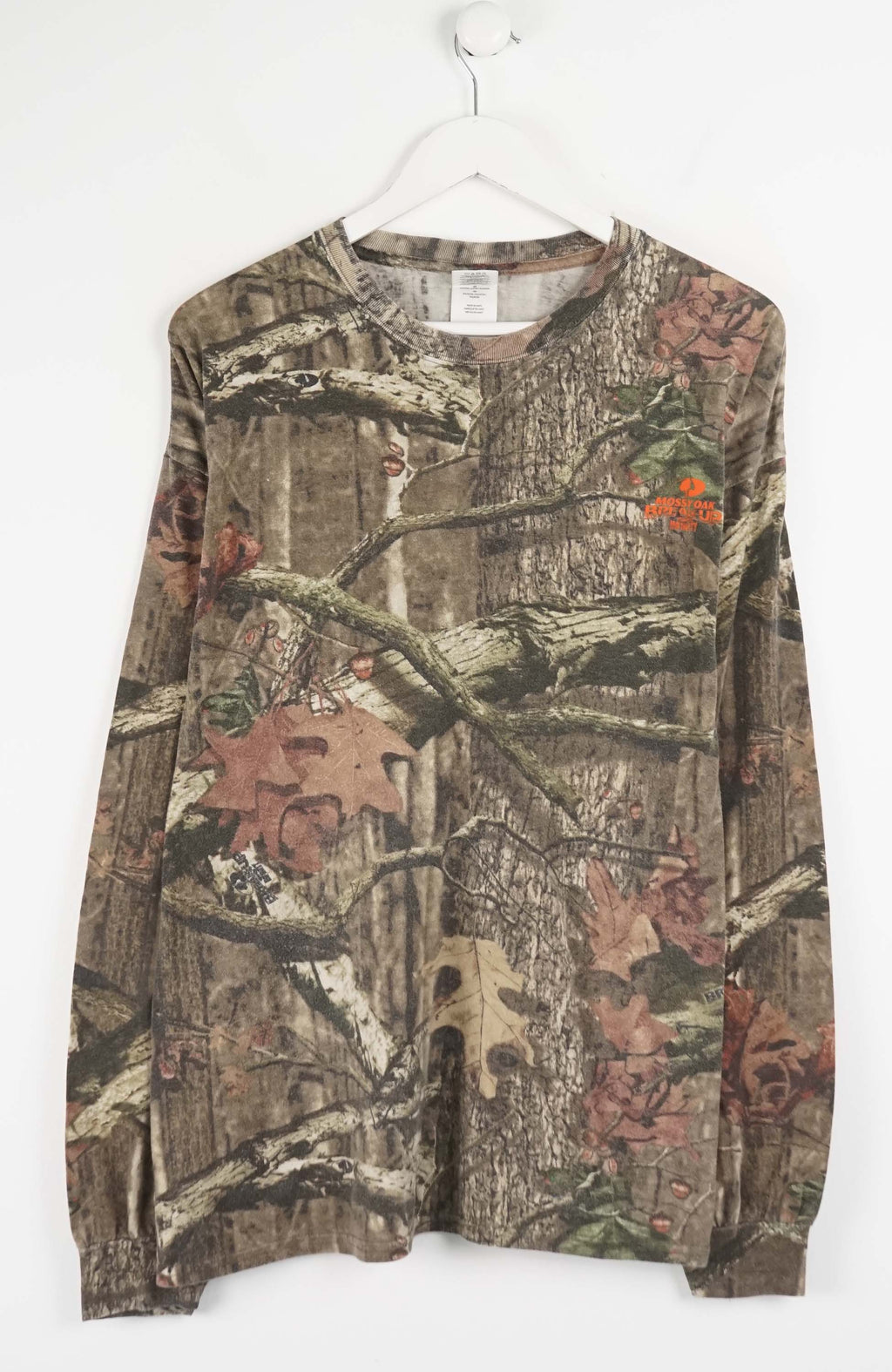 Camouflage-patterned long-sleeve shirt on a white hanger