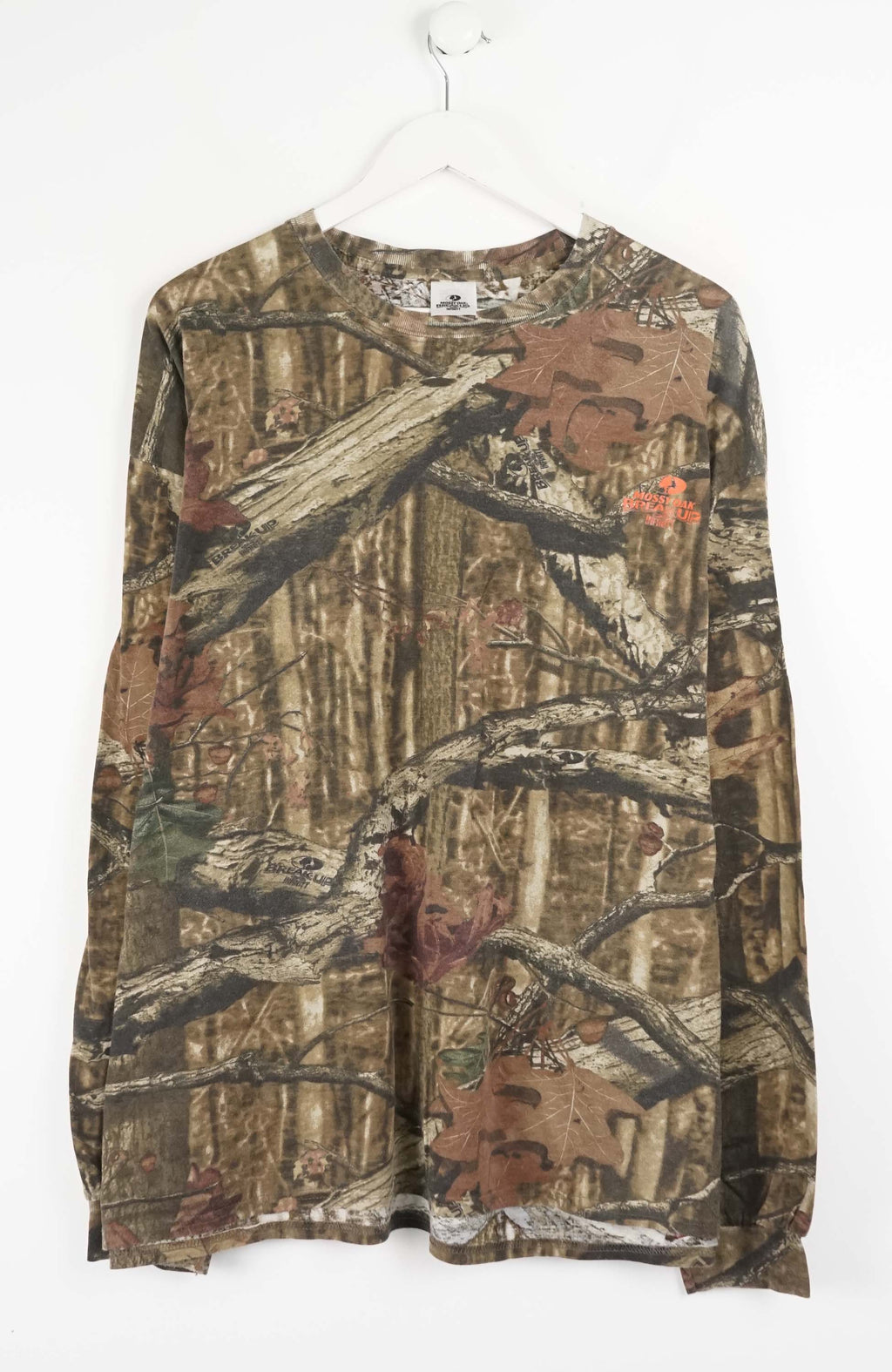 Camouflage-patterned long-sleeve shirt with tree branch and animal design on a white background